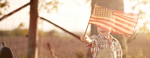 Kid holding american flag (620-240)